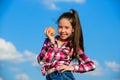 Fruit vitamin nutrition for kids. Apple fruit diet. Kid hold ripe apple sunny day. Kid girl with long hair eat apple Royalty Free Stock Photo