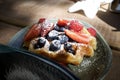 Fruit waffle in a plate on a wooden table Royalty Free Stock Photo