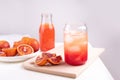 Fruit water in a glass with ice cubes, blood orange lemonade, summer refreshing drink on a white background Royalty Free Stock Photo