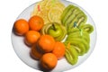 Fruit white plate with tangerines, kiwi, sliced apple and lemon slices on background isolated Royalty Free Stock Photo