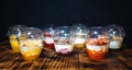 Fruit yogurts on black background. Healthy breakfast on the wooden table.