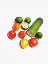 fruits arranged on a white background. There are several red tomatoes.