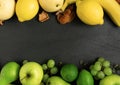 fruits background green and yellow color set, dark stone slake plate with copy space. Flat lay top view. Summer abstract creative