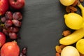 fruits background yellow and red color set, dark stone slake plate with copy space. Flat lay top view. Summer abstract creative tr