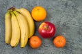 Fruits. Bananas, apples, oranges, tangerines on a biton background Royalty Free Stock Photo