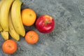 Fruits. Bananas, apples, oranges, tangerines on a biton background Royalty Free Stock Photo