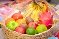 All fruits like Banana, Sweet lemon, orange, pomegranate, Apple, Dragon fruits in basket isolated on white background. Royalty Free Stock Photo