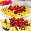 Fruits and berries on plate on the festive table. Royalty Free Stock Photo