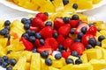 Fruits and berries on a plate on the table. Royalty Free Stock Photo