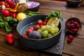 Fruits and berries in plate on wooden background Royalty Free Stock Photo