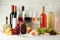 Fruits, cheese, bottles and glasses with different wine on white background Royalty Free Stock Photo