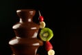 Fruits in chocolate fountain Royalty Free Stock Photo