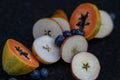 Fruits close up on black stone background Royalty Free Stock Photo