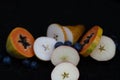 Fruits close up on black stone background Royalty Free Stock Photo