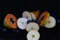 Fruits close up on black stone background Royalty Free Stock Photo