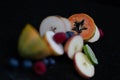 Fruits close up on black stone background Royalty Free Stock Photo