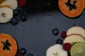 Fruits close up on black stone background Royalty Free Stock Photo