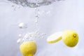 fruits dropped into water and splashing water Royalty Free Stock Photo