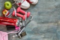 Fruits, dumbbells, a bottle of water, rope, sneakers and a meter on a blue with divorce background Royalty Free Stock Photo