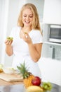 Fruits, eating grapes or happy woman with healthy morning meal or lunch meal or diet in kitchen at home. Breakfast Royalty Free Stock Photo