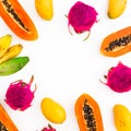 Fruits frame with banana, papaya, yellow mango and dragon fruits on white background. Flat lay. Top view. Tropical fruit