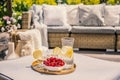 Fruits and glass with water on rattan table on the terrace with Royalty Free Stock Photo