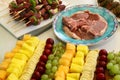 fruits and grilled meats, bananas, pineapples, cherries, grapes, melon, meat skewers, lamb chops, meatballs Royalty Free Stock Photo