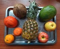 Fruits on iron tray on wooden table