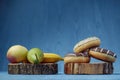 fruits lying on the table againts donuts Royalty Free Stock Photo
