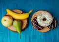 fruits lying on the table againts donuts Royalty Free Stock Photo