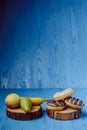 fruits lying on the table againts donuts Royalty Free Stock Photo