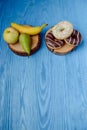 fruits lying on the table againts donuts Royalty Free Stock Photo