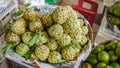 Fruits at the market. Annona squamosa. sugar-apples or sweetsops with oranges in Vietnam. Tropical fruit. Harvest and commerce