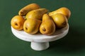 Fruits. Pears and apple fruits on white stone cake stand Royalty Free Stock Photo