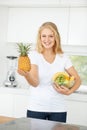 Fruits, pineapple or portrait of happy woman with healthy lunch or breakfast meal or diet in kitchen at home. Morning Royalty Free Stock Photo