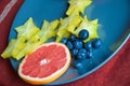 Fruits on a plate- Grapefruit, star fruit and blueberries ready to eat Royalty Free Stock Photo