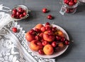 Fruits on the plate. Grey wooden table with white napkin Royalty Free Stock Photo