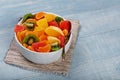 Fruits salad in plate on blue wooden table Royalty Free Stock Photo