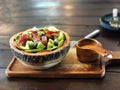 Fruits salad in wooden tray and salad dressing on wooden tray. Smart eating.