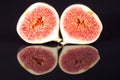 Fruits of sectioned fresh figs on black background Royalty Free Stock Photo