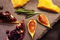 Fruits and slices of hard cheese on a background of dark stone countertops. Still life of healthy products. Close-up Royalty Free Stock Photo