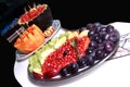 Fruits variety . black plum , Pomegranate . apple , grapes .