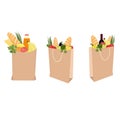 Fruits, vegetables, bread, bottled beverages, and wine in brown grocery bag isolated on white background.