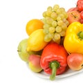 Fruits and vegetables on a dish isolated on a white. There is free space for text Royalty Free Stock Photo