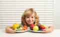 Fruits and vegetables. Kid boy eating healthy food vegetables. Breakfast with milk, fruits and vegetables. Child eating Royalty Free Stock Photo