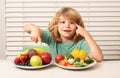 Fruits and vegetables. Kid boy eating healthy food vegetables. Breakfast with milk, fruits and vegetables. Child eating Royalty Free Stock Photo