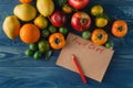 Fruits, vegetables and in measure tape in diet on wooden background Royalty Free Stock Photo