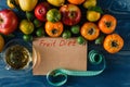 Fruits, vegetables and in measure tape in diet on wooden background Royalty Free Stock Photo