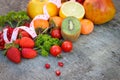 Fruits, vegetables and in measure tape in diet on wooden background Royalty Free Stock Photo