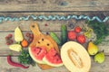 Fruits, vegetables and in measure tape in diet on wooden background. Royalty Free Stock Photo